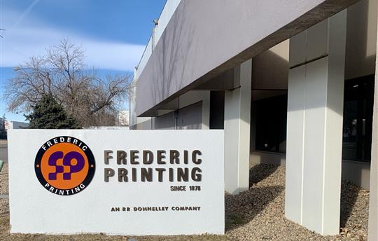 Frederic Printing Company sign and building outdoor against blue sky